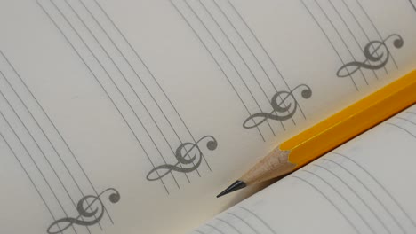 pencil on music note book in rotation