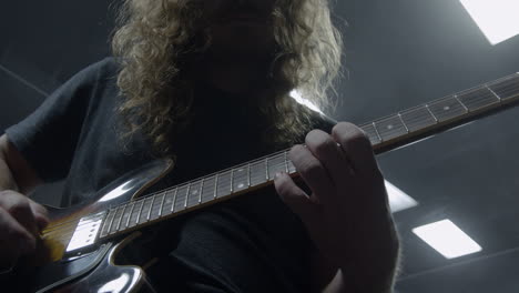 stylish rock musician playing electric guitar