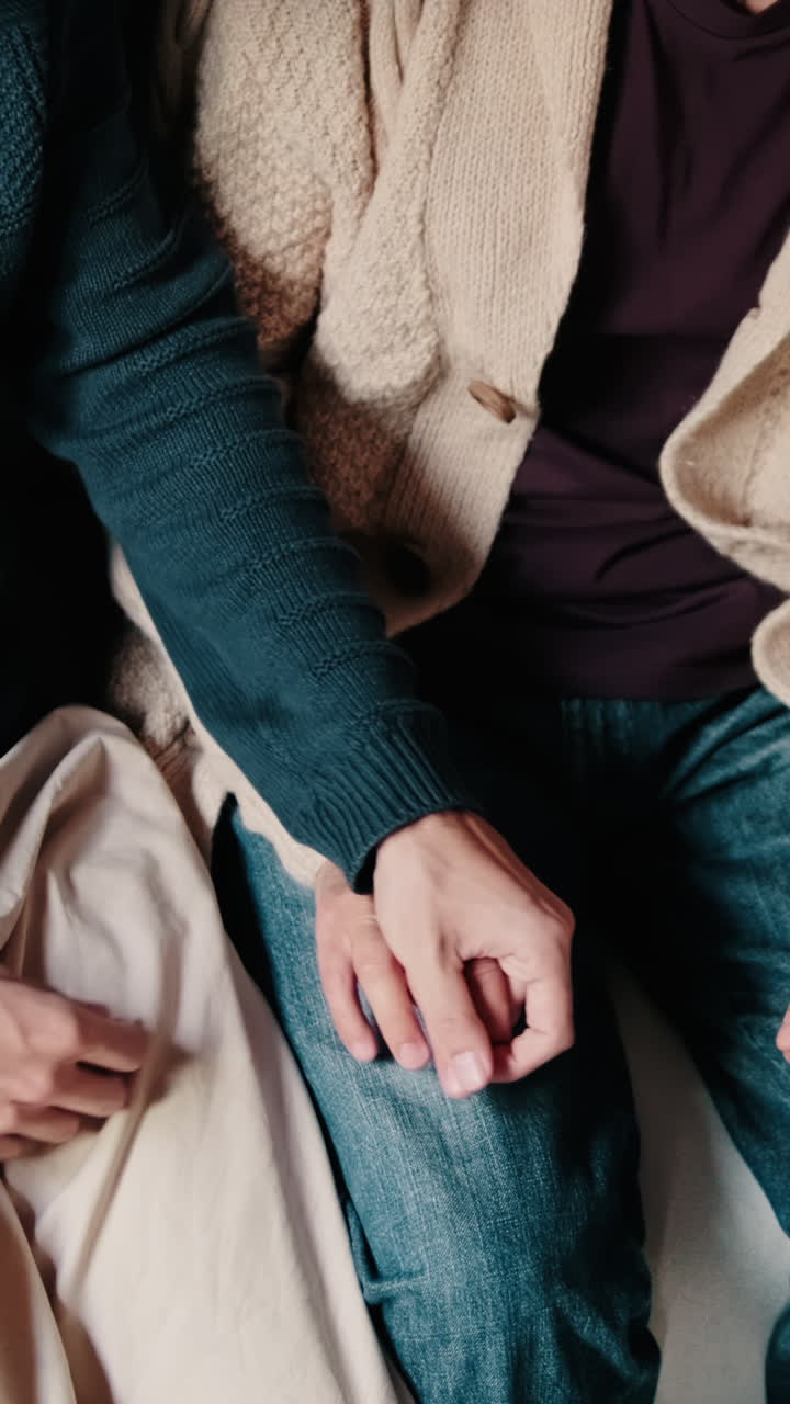 Gay Couple Holding Hands at Home