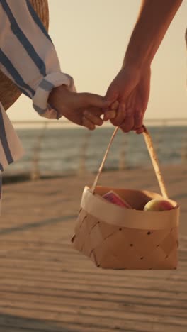 couple on a beach picnic at sunset