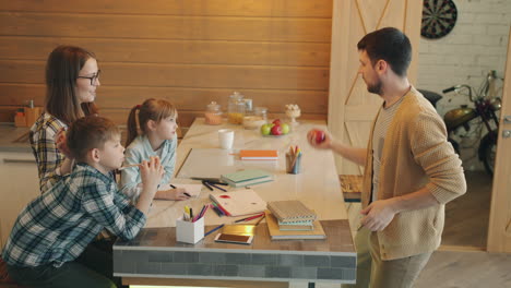 happy family doing homework and playing in the kitchen