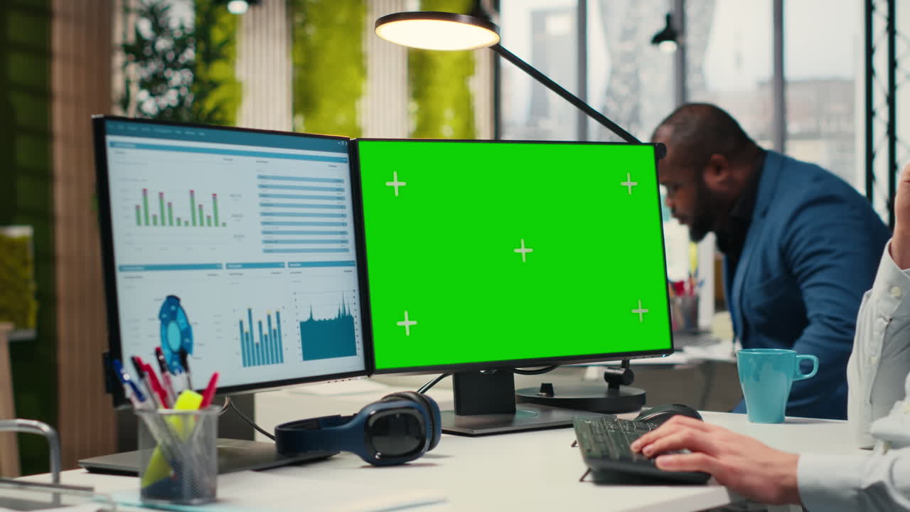 Employee engaged in business planning with a green screen in the office