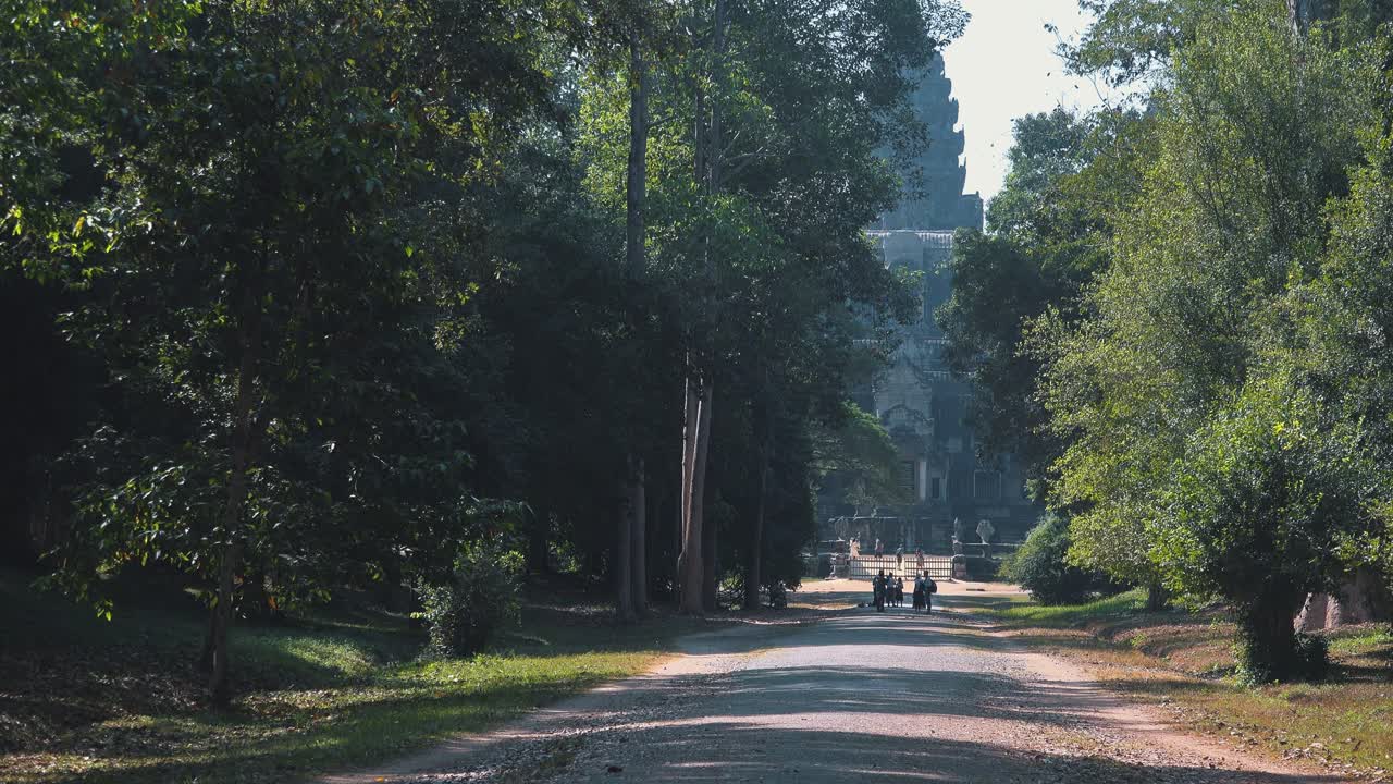 Ancient Temple Near Angkor Wat Seen Through the Trees Down a Long Path in the Forest