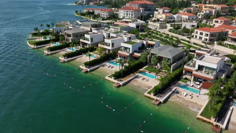 aerial establishing fly at portnovi montenegro, resorts complex in adriatic sea landscape with mountain background