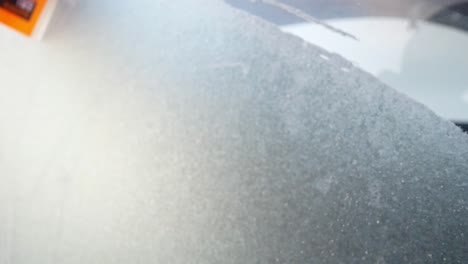 scraping ice off a car window