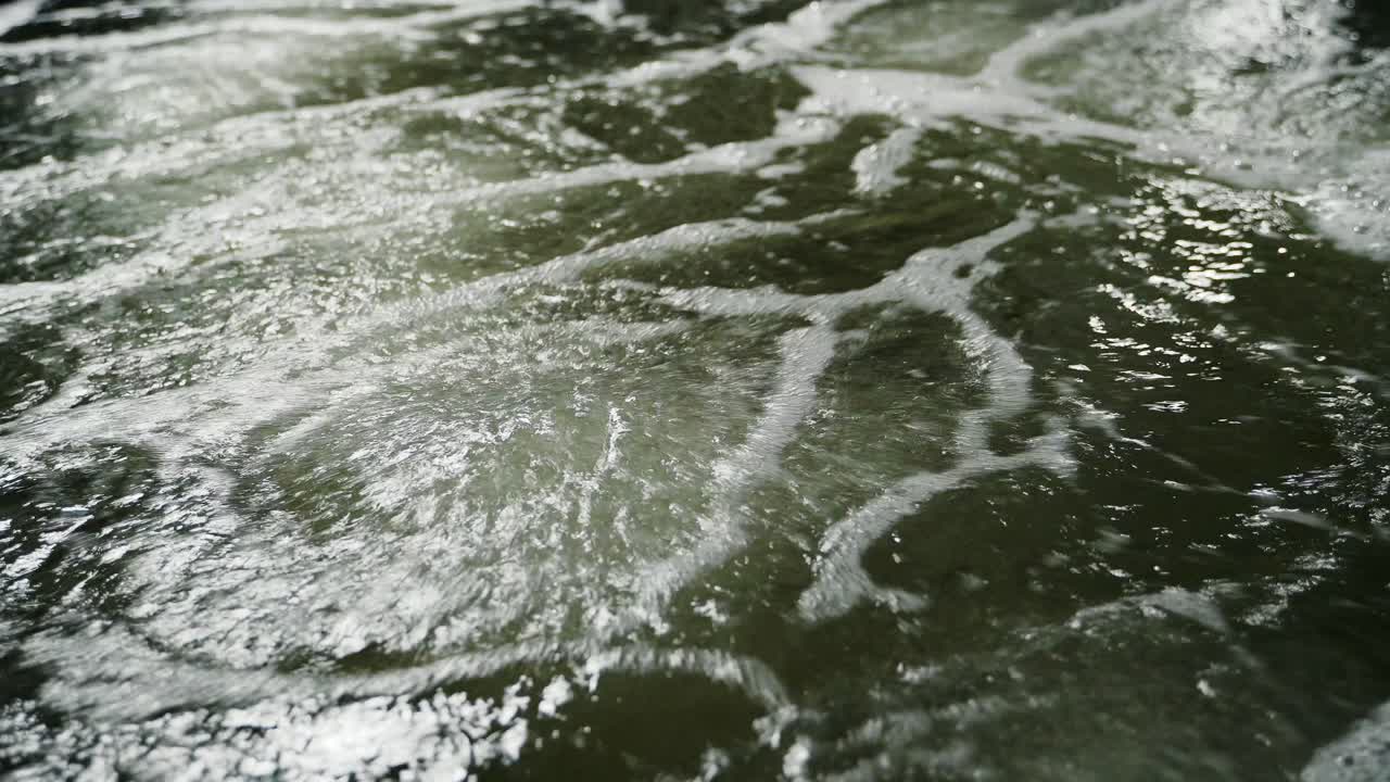 Aeration of shrimp pool water. Air bubbles rising up. Shrimp Farm. Shooting close-up