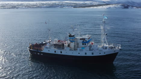 Aerial-Drone-view-Polar-Fjord-Cruise-Ship-Sailing-in-the-Arctic-Sea-in-Tromso,-Norway