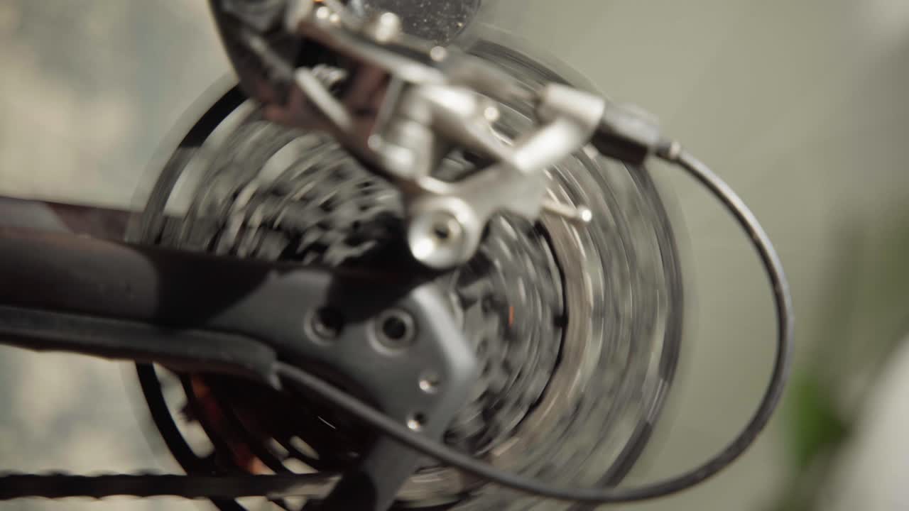 Close-up of bicycle gears and chain spinning rapidly. Dynamic and detailed, perfect for cycling, mechanics, and sports content
