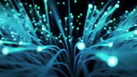 in a dark environment, colorful light beams radiate from fiber optic cables, showcasing intricate patterns and illuminating the surroundings.