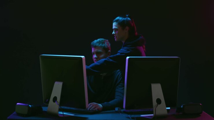 Man and woman working on computers