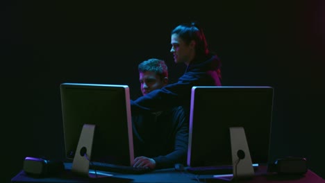 Man and woman working on computers