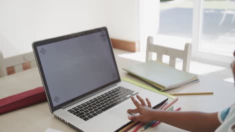 African-american-boy-using-laptop-with-copy-space-on-screen,-in-slow-motion