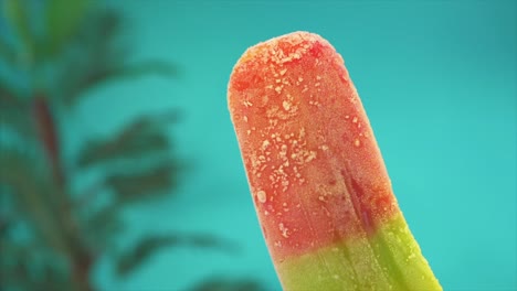 As-ice-cream-defrosts,-its-colorful-mass-diminishes-and-transforms-into-sweet-liquid,-captured-in-a-close-up-against-a-blue-background,-conveying-an-artistic-concept-of-summertime