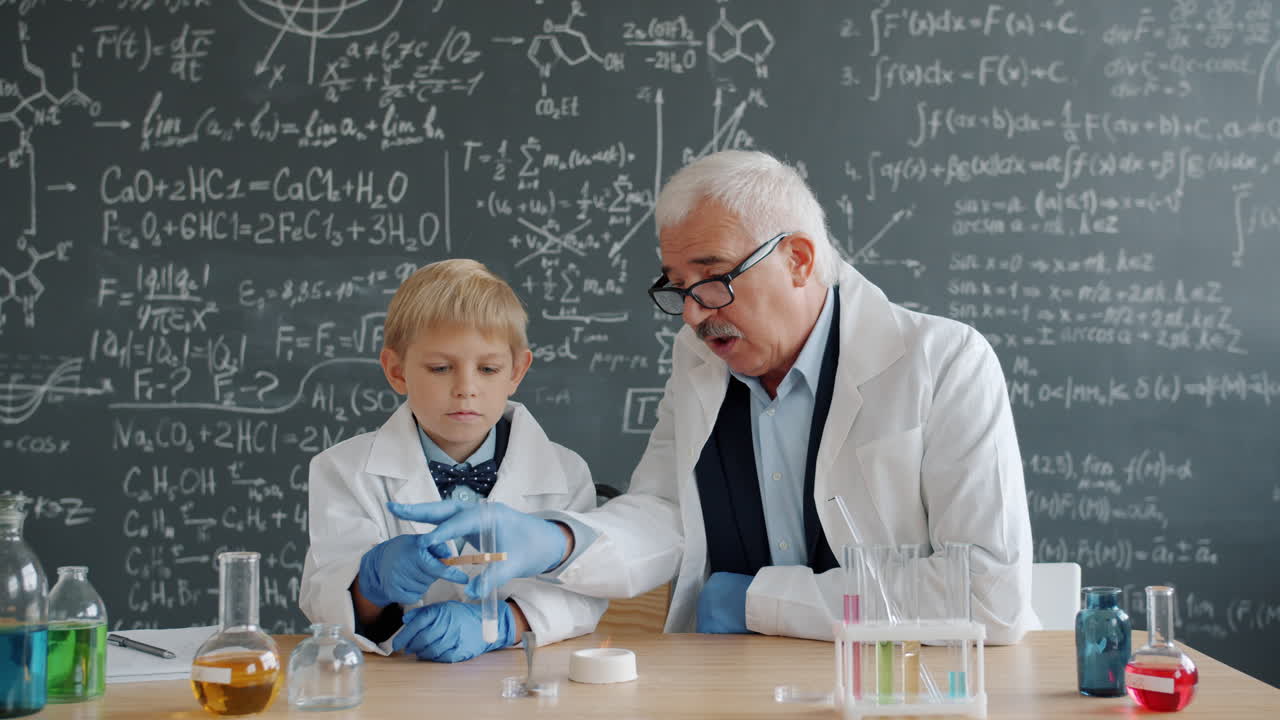 Young Boy and Teacher Conducting a Chemistry Experiment