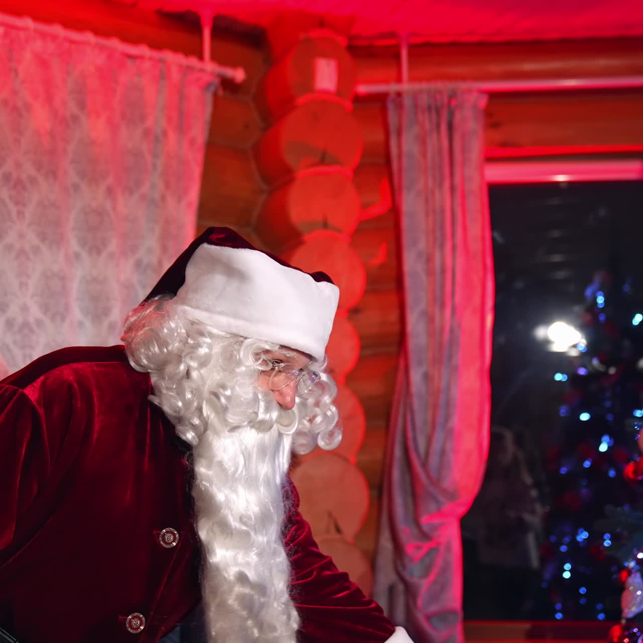 Santa Claus with kids at home. New Year eve with Santa in the room with the Christmas decorations