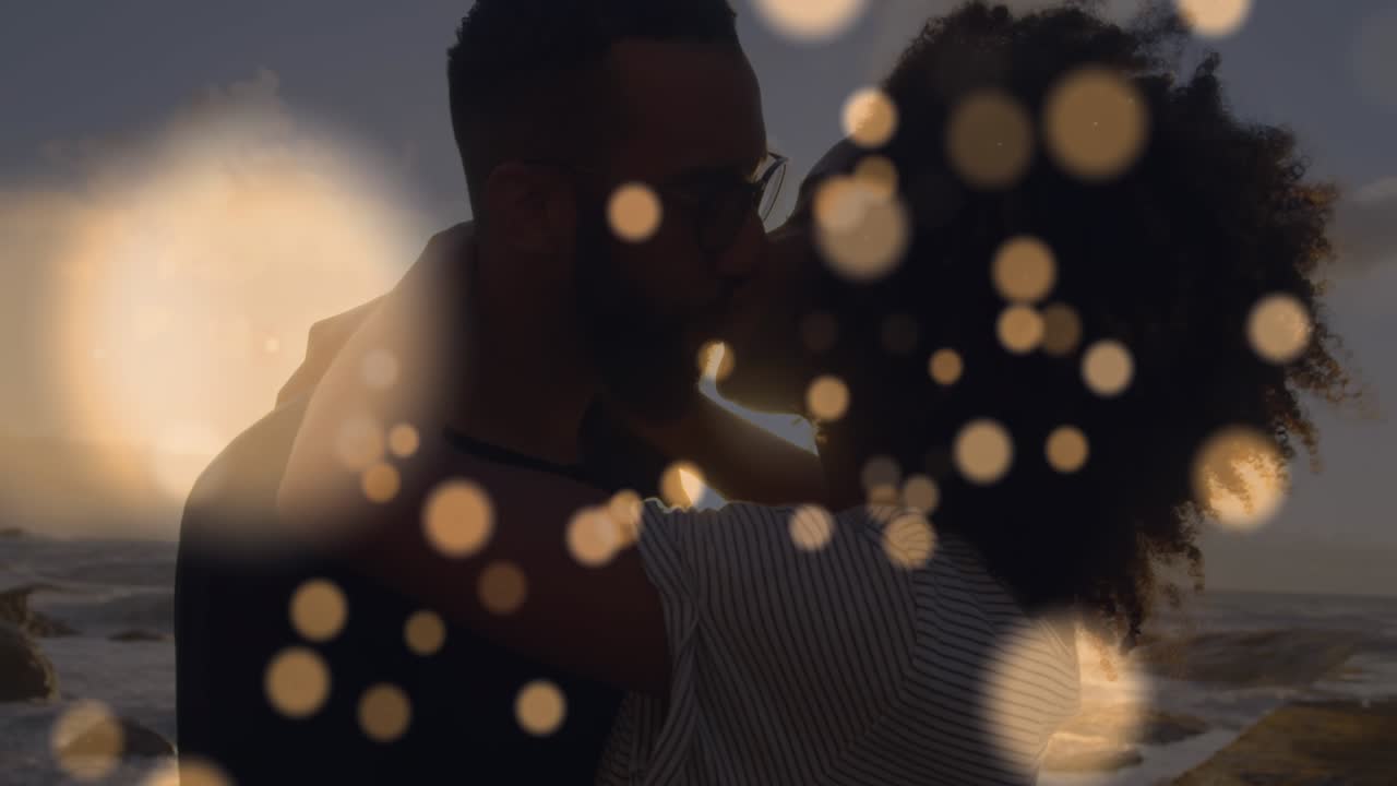 Animation of light spots over african american couple at beach