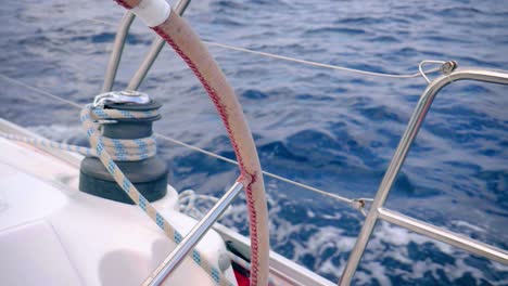 view of sea through steering wheel of forward propelling yacht