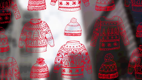 animación de sudaderas y sombreros navideños sobre el fondo del paisaje urbano