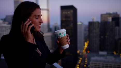 latin american businesswoman using mobile technology on rooftop