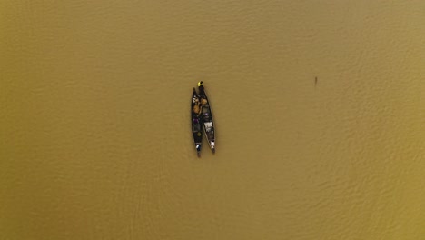 fishermen paddling on a lake in west africa