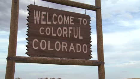 a roadside sign welcomes visitors to colorado 1