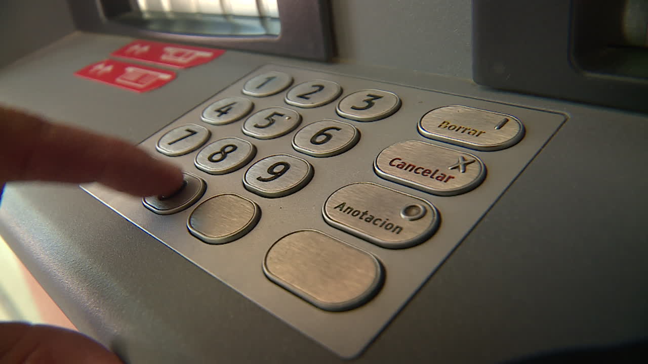 Person Entering PIN at ATM