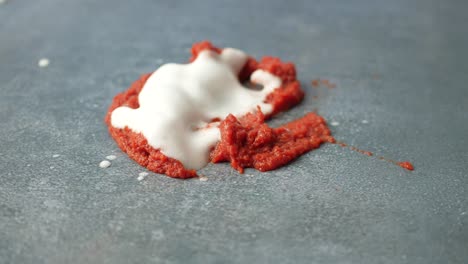 cleaning up a tomato sauce spill with foam