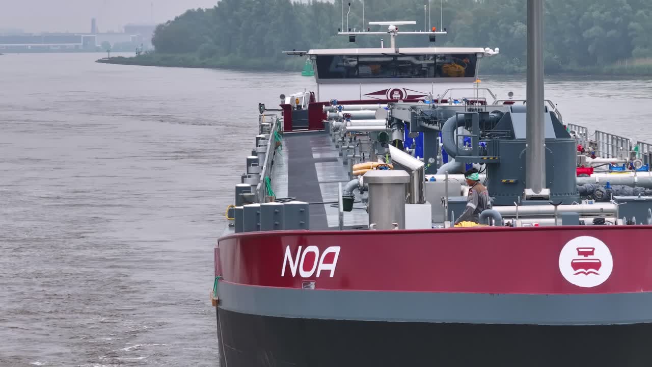 Large Cargo Ship 'NOA' Navigating a River