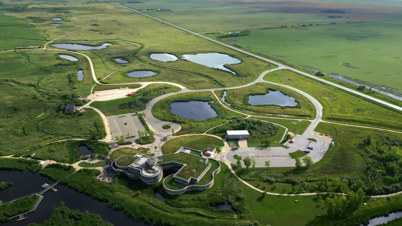 Overhead perspective captures entire protected environment campus, roads, paths, and lush wetlands