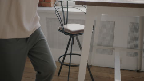 man in a cafe with a coffee and phone