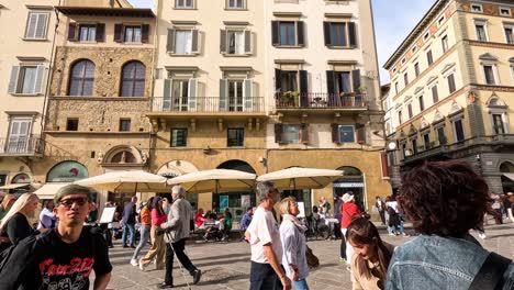 people walking in a bustling city square