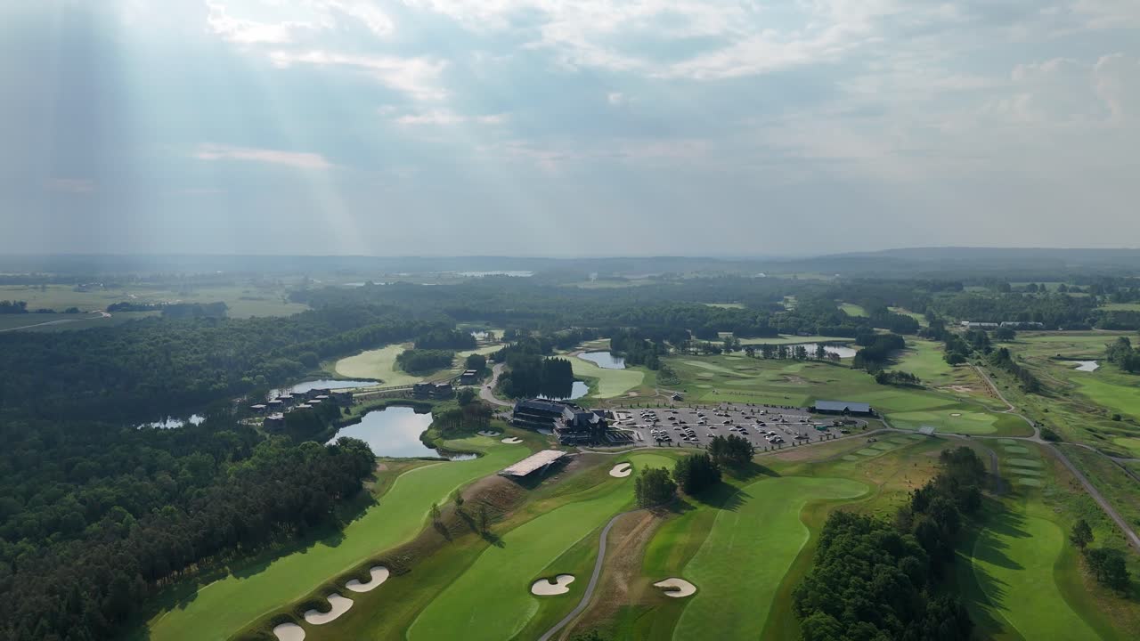 Drone flying above fairway at TPC Toronto golf course with trees and open sky