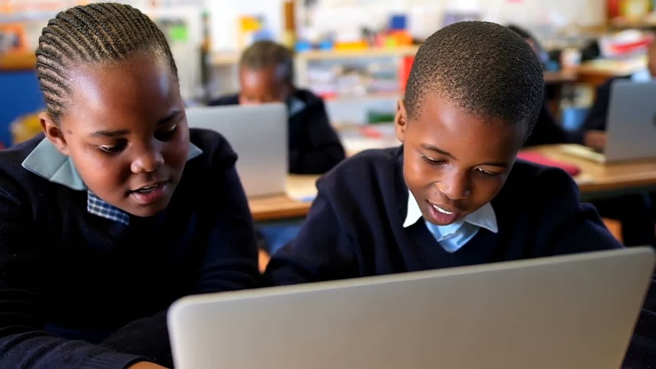 Schoolkids using laptop in classroom 4k