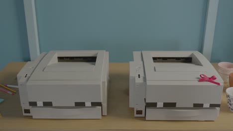 Two-Old-Printers-in-a-Colourful-Modern-Office-Setting,-Camera-Dollies-in