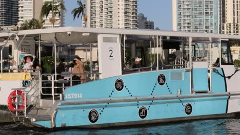 turquoise ferry boat cruising on a river