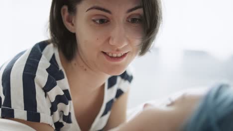 Close-up-handheld-video-of-lesbian-couple-talking-in-bed.