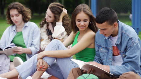 students sitting on running track