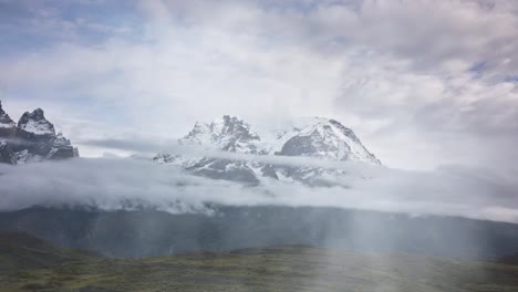 mountain range in patagonia with clouds in foreground