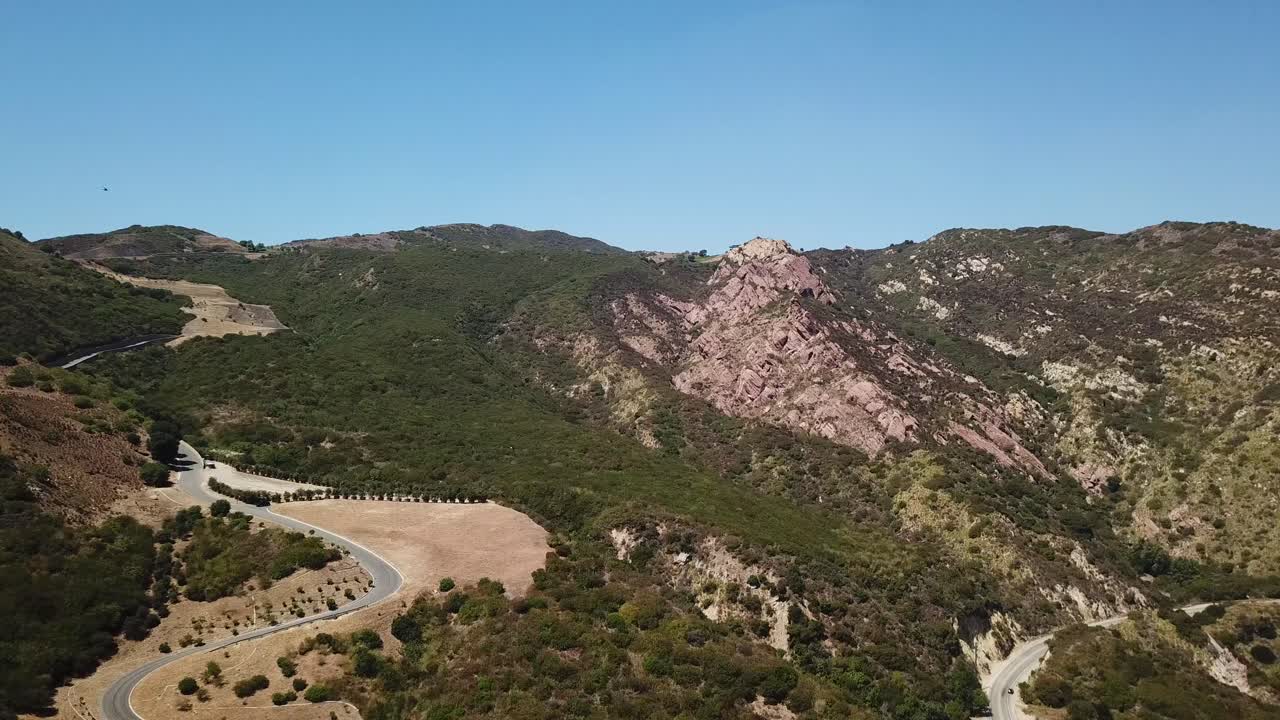 carretera entre las verdes montañas de santa mónica de malibu en un soleado día de verano con cielo azul