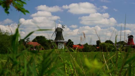 beautiful-old-windmills-in-the-distance-in-a-field-in-good-weather