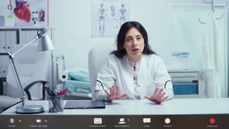 woman doctor talking to camera and giving online medical consultation
