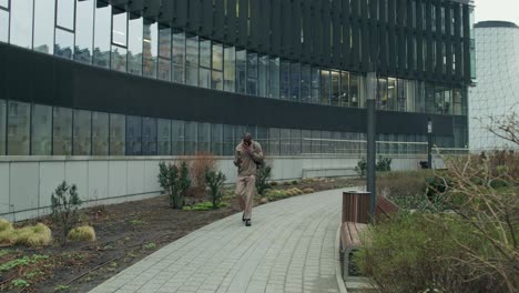 man walking through city park