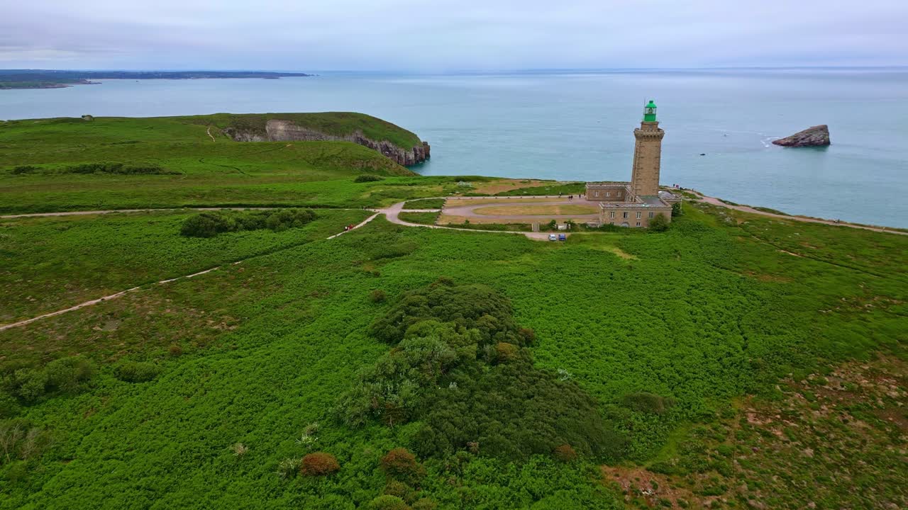 Approaching drone movement to the Cap Fréhel peninsula and lighthouse, Côtes-d'Armor, Brittany, France.