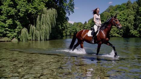 woman horseback riding in a river