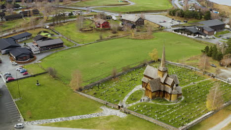 view of lom stave church , morning scene of norwegian countryside, administrative centre of lom municipality - aerial drone shot