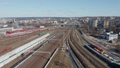 aerial: flying over train rails with idling trains on a cold chilly day in vilnius