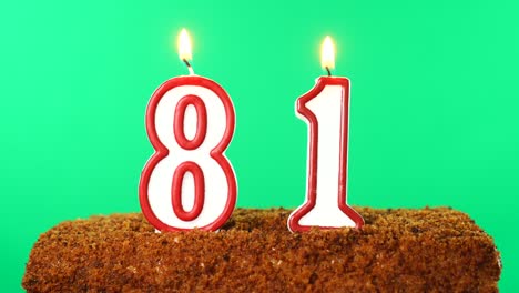 cake with the number 81 lighted candle. chroma key. green screen. isolated