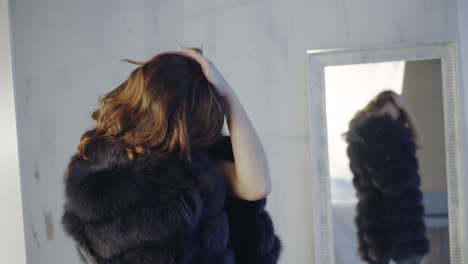young woman posing in lingerie and fur coat. the girl takes off her fur coat