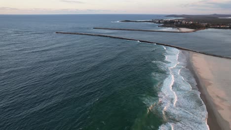 waves coming to the sandy shore of iluka beach in new south wales, australia