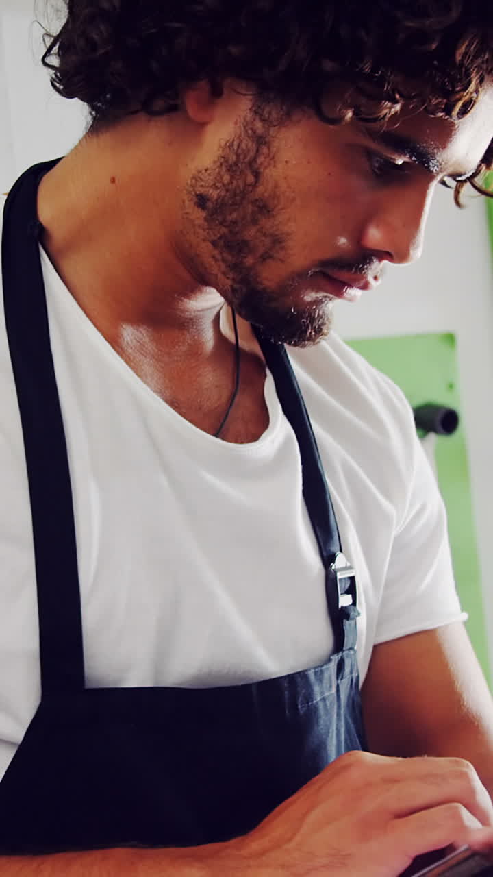 Mechanic using digital tablet in workshop